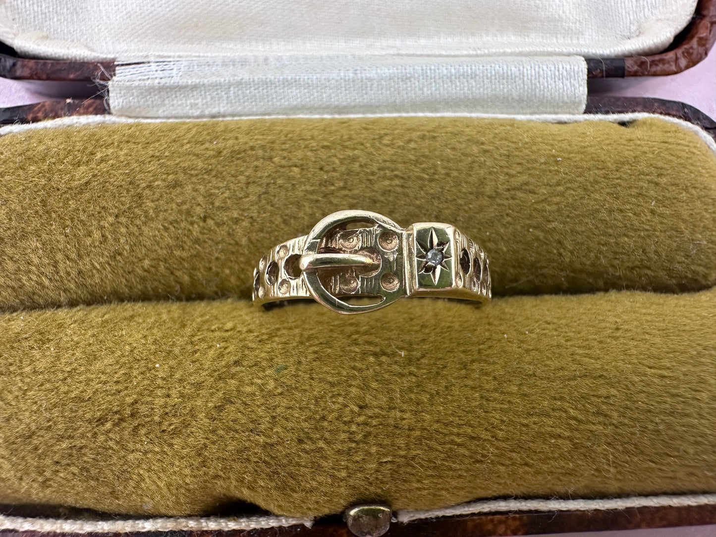 Vintage 9ct Gold Buckle ring with a star set accent diamond.