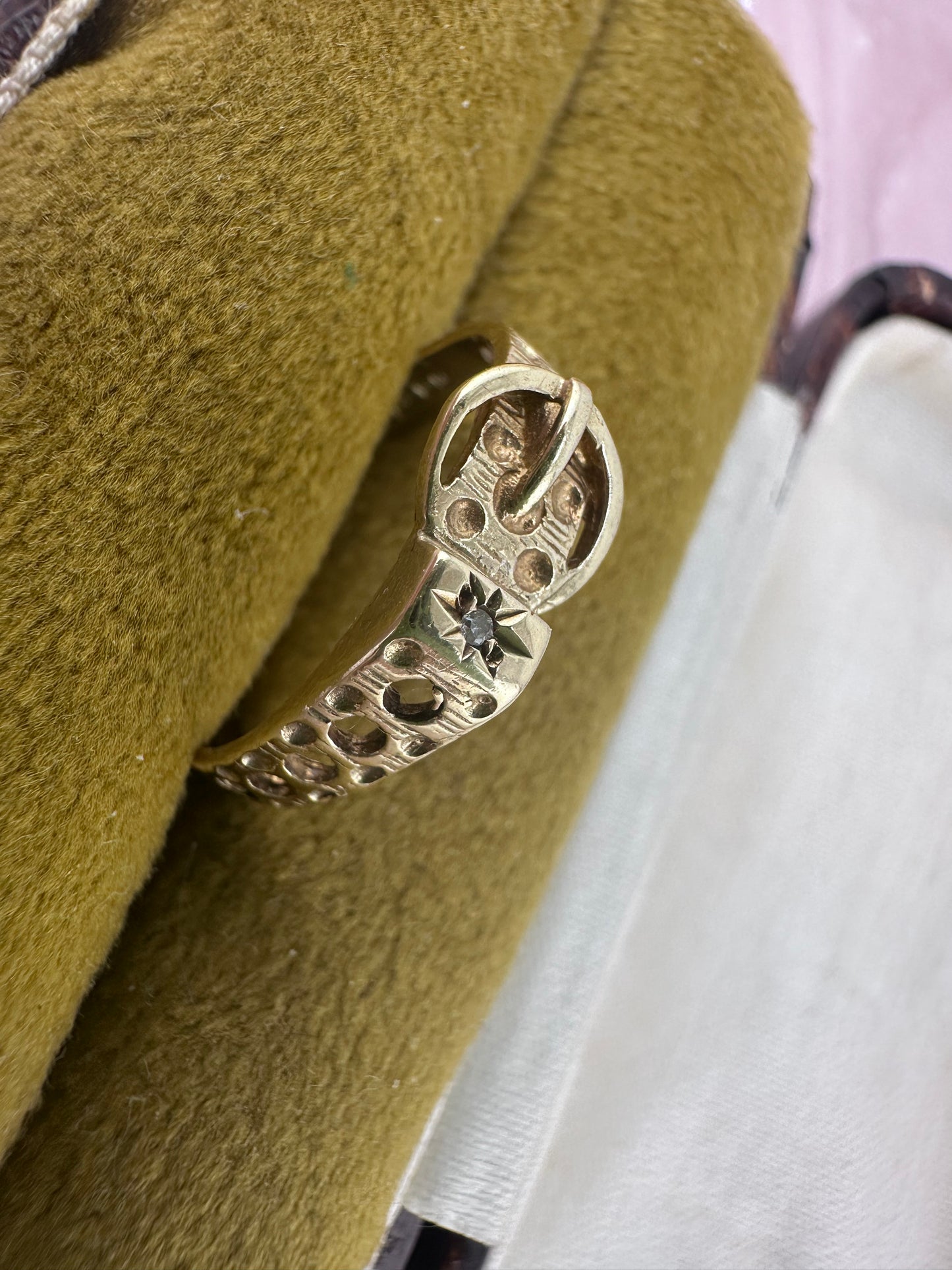 Vintage 9ct Gold Buckle ring with a star set accent diamond.