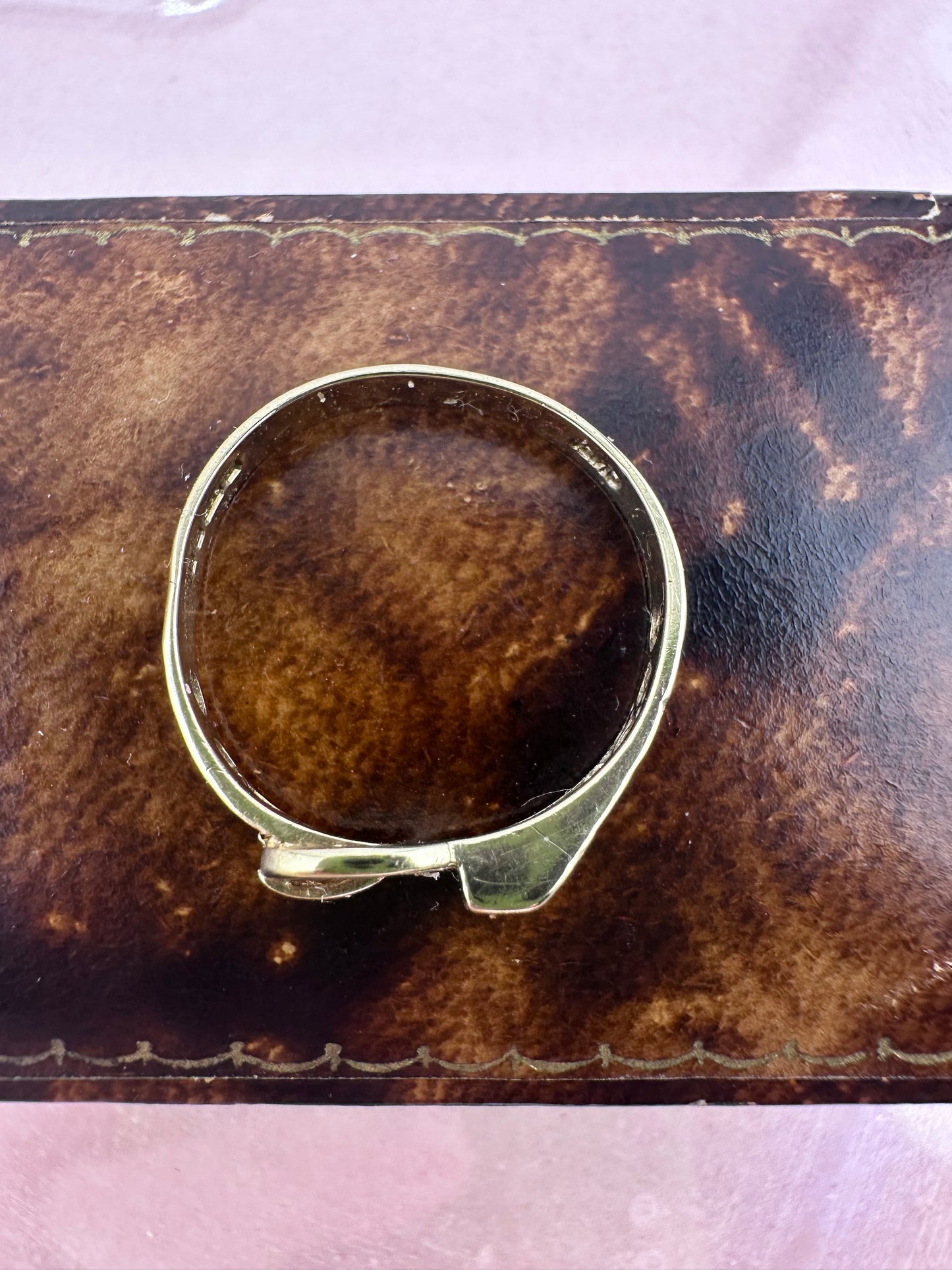 Vintage 9ct Gold Buckle ring with a star set accent diamond.