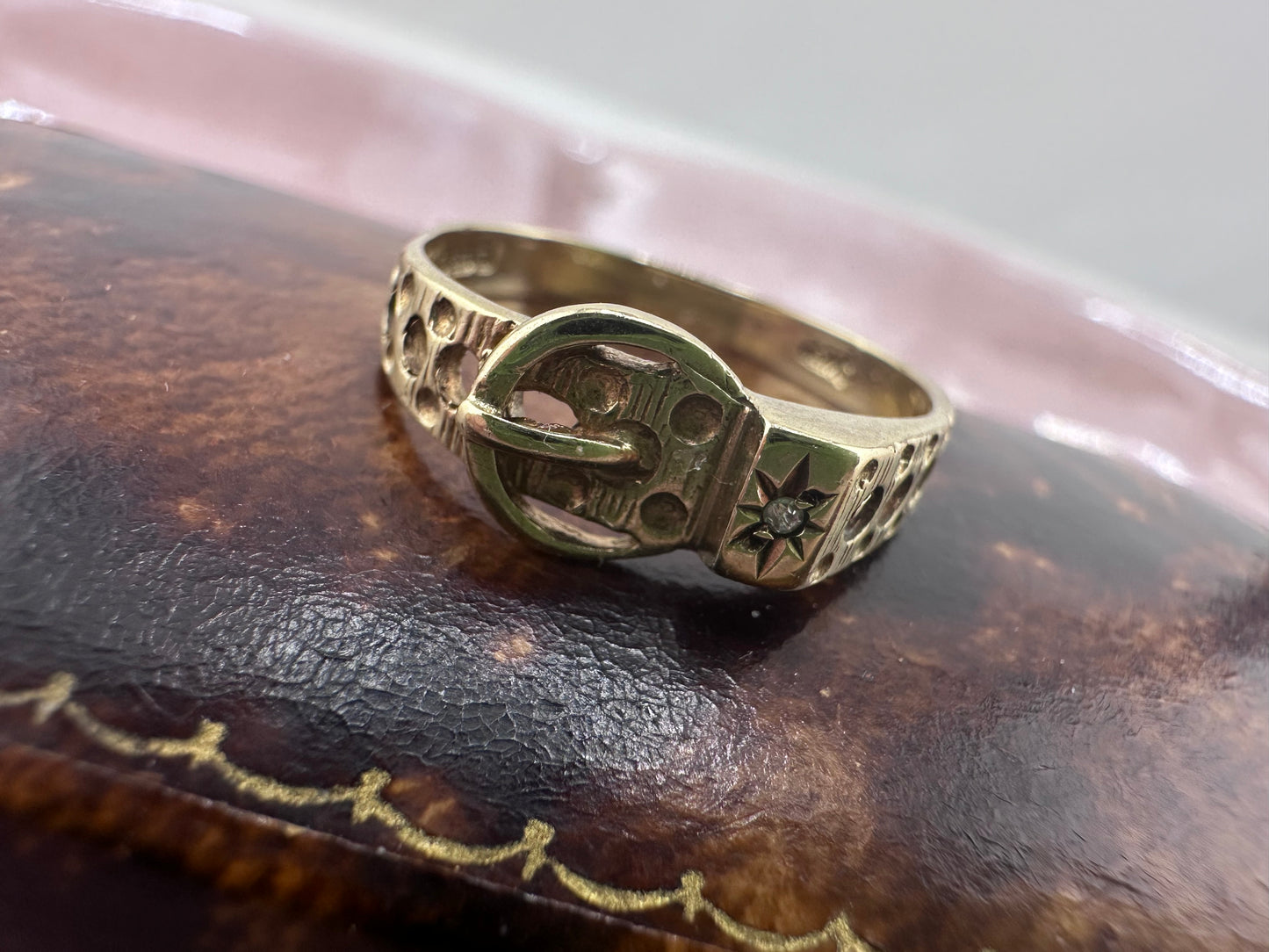 Vintage 9ct Gold Buckle ring with a star set accent diamond.
