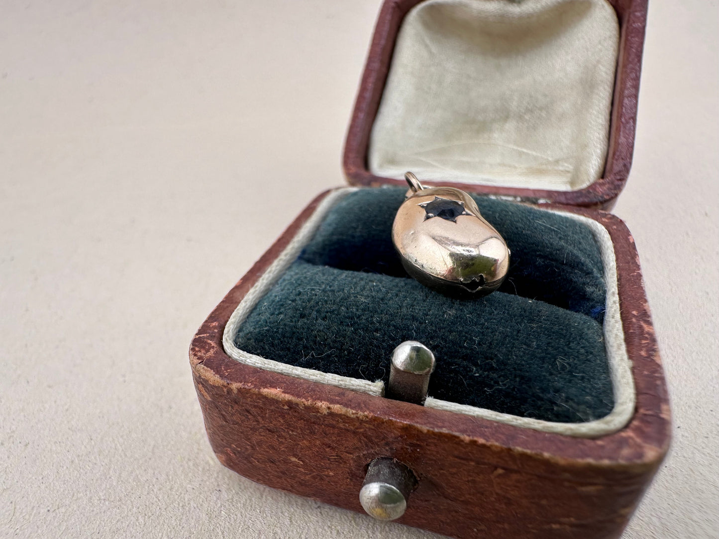 Antique 9ct gold Lucky Bean Charm with star set Iolite