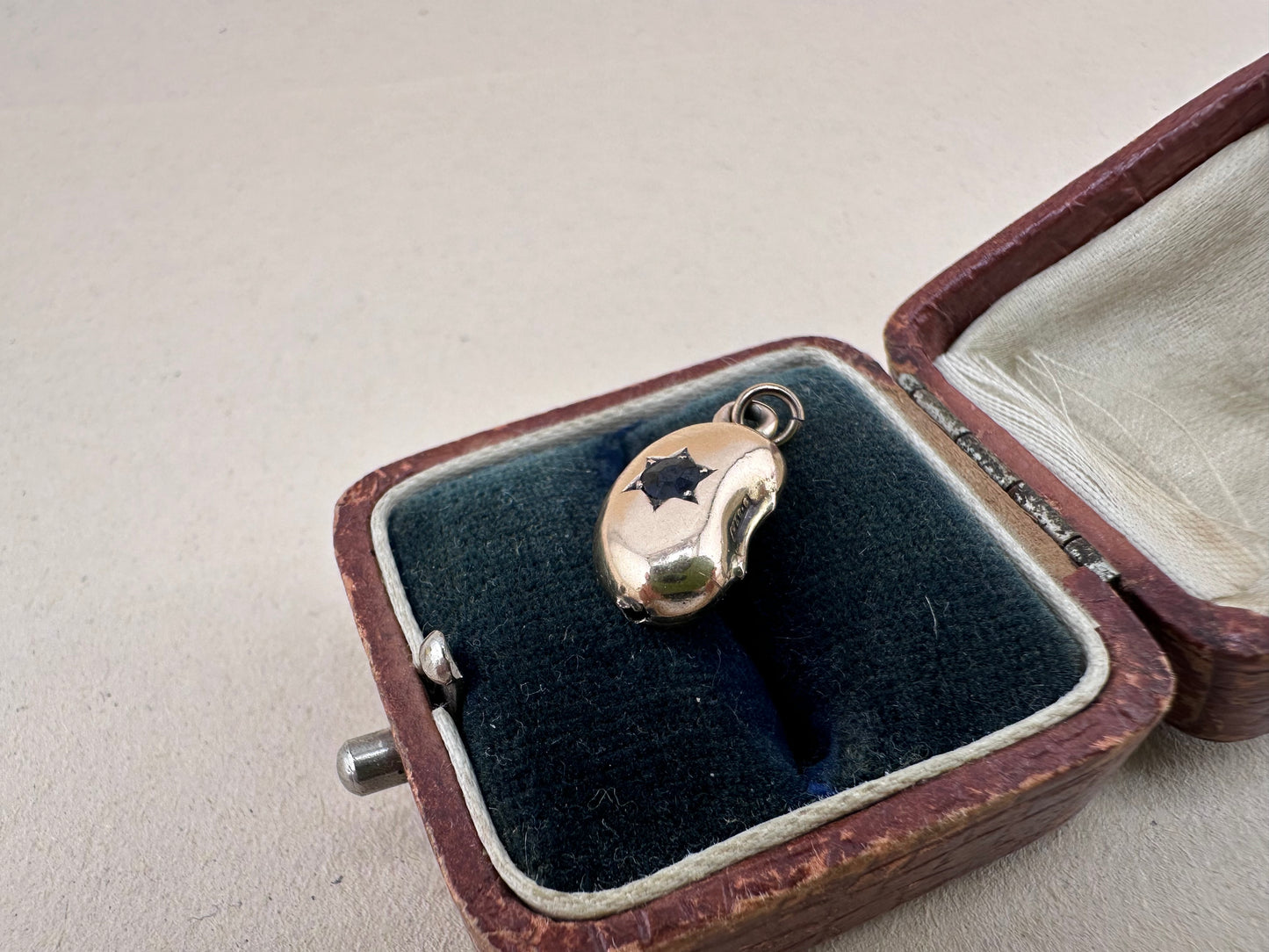 Antique 9ct gold Lucky Bean Charm with star set Iolite