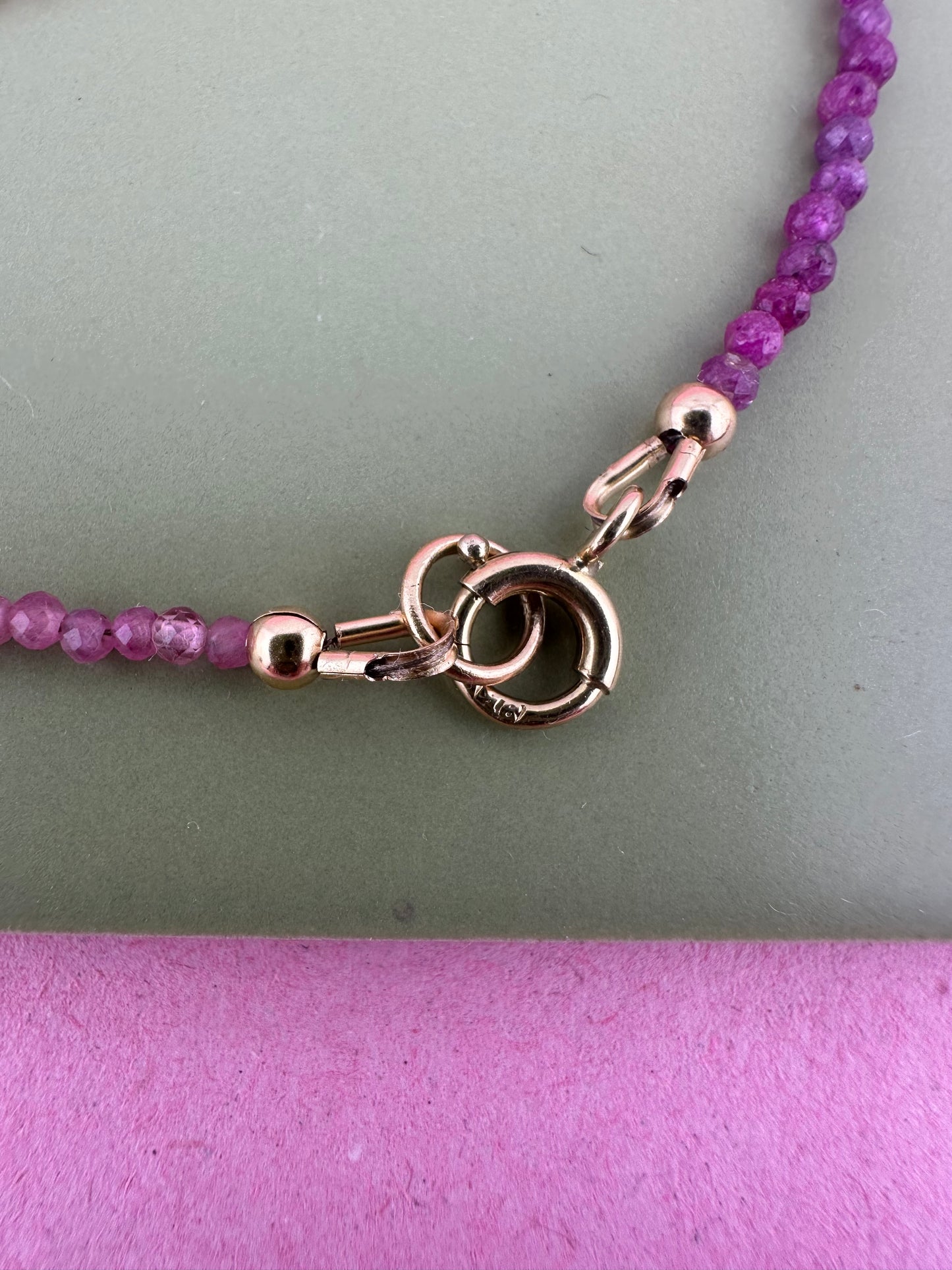 Ruby & Pink tourmaline half and half mini beads with antique 9ct gold bolt clasp and central bead.