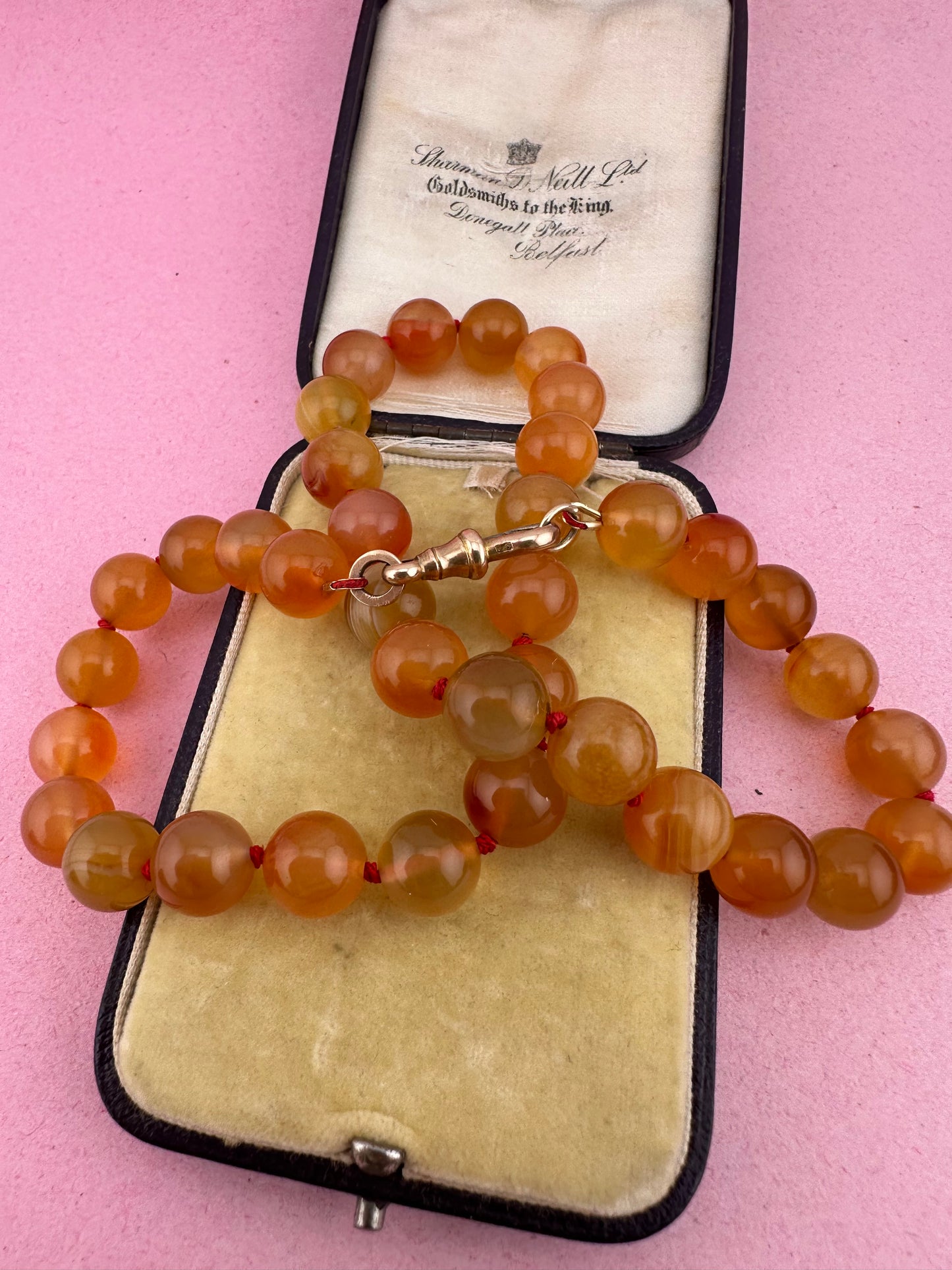 Re-imagined Orange Agate beads with Antique Dog clip