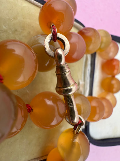 Re-imagined Orange Agate beads with Antique Dog clip