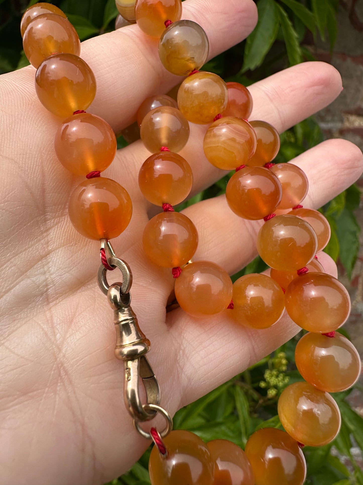 Re-imagined Orange Agate beads with Antique Dog clip