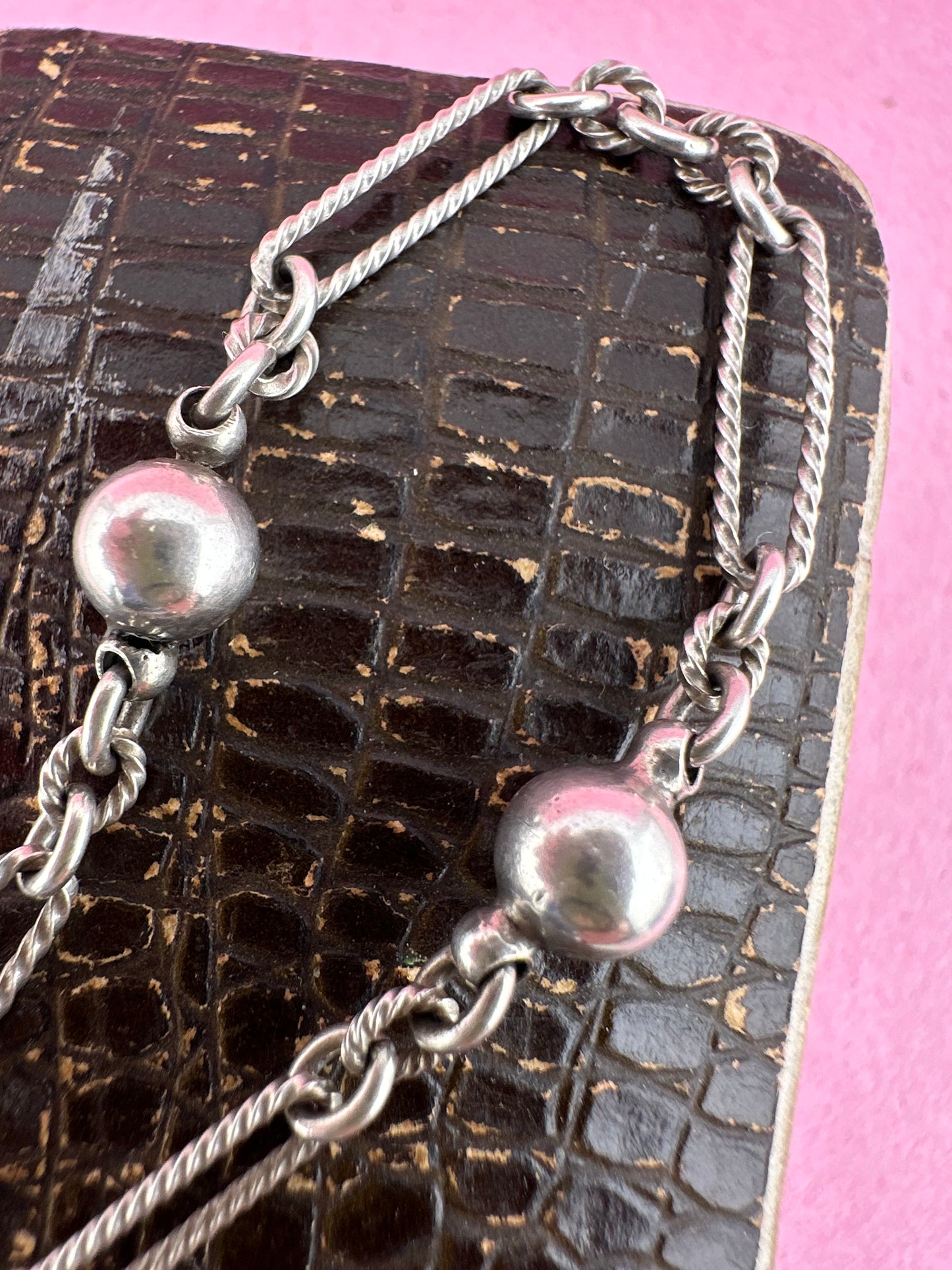 Antique Sterling Silver twist trombone and ball link bracelet with heart charm.