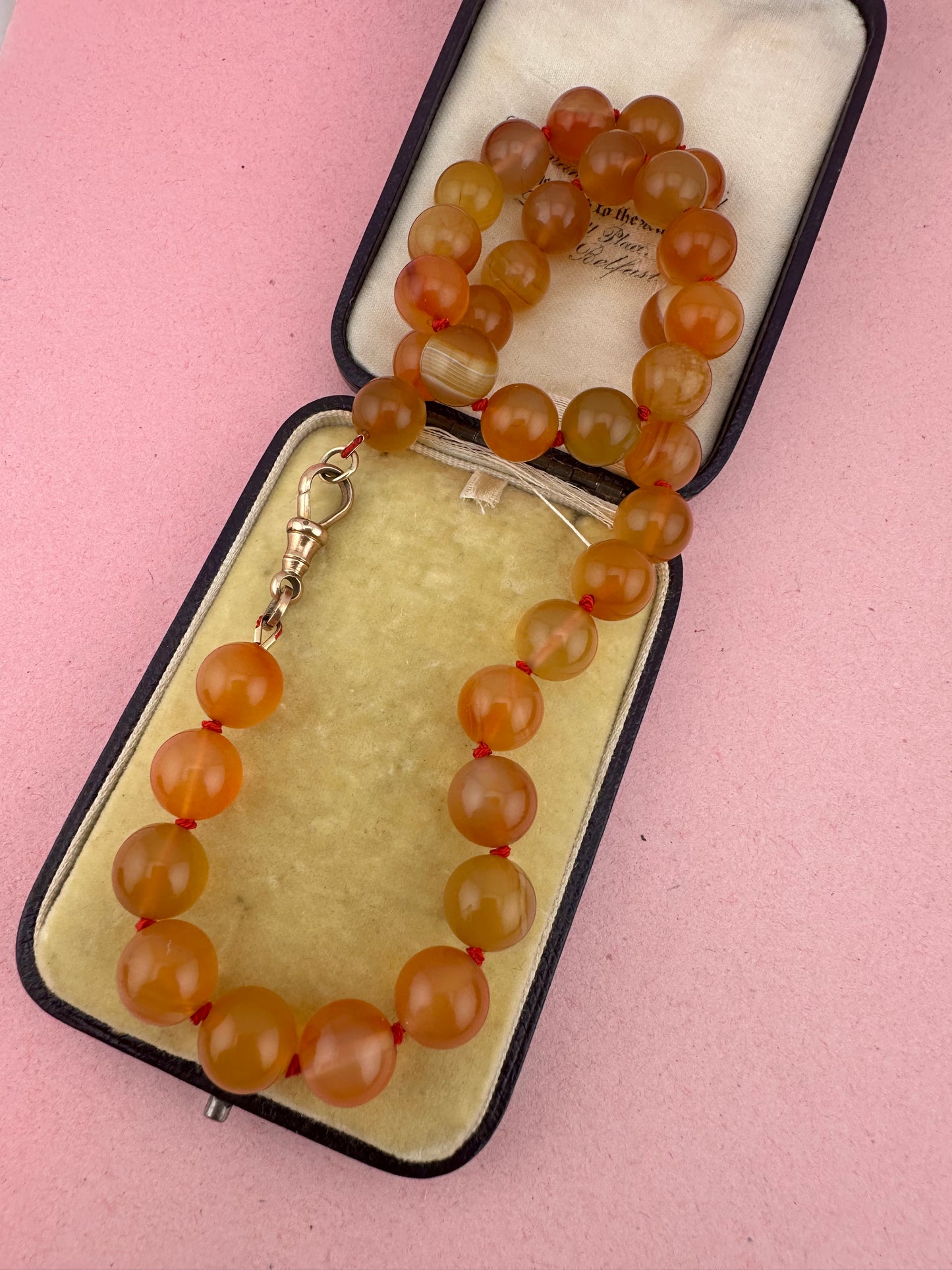 Re-imagined Orange Agate beads with Antique Dog clip