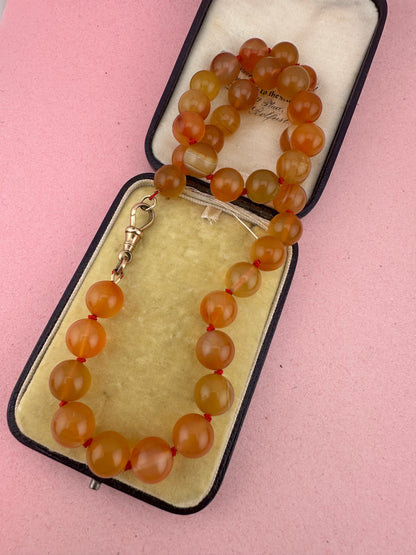 Re-imagined Orange Agate beads with Antique Dog clip