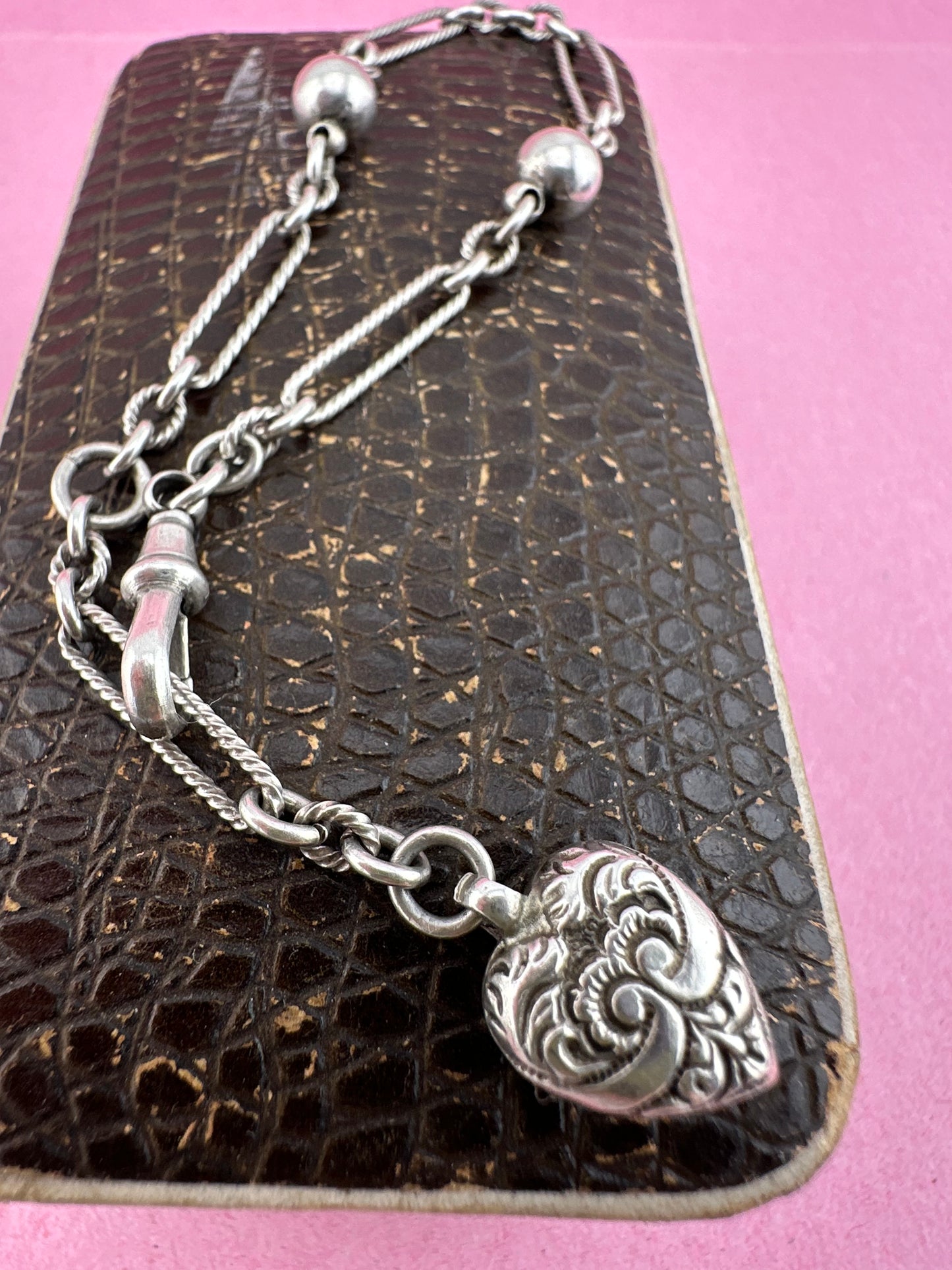 Antique Sterling Silver twist trombone and ball link bracelet with heart charm.