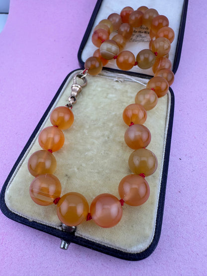 Re-imagined Orange Agate beads with Antique Dog clip