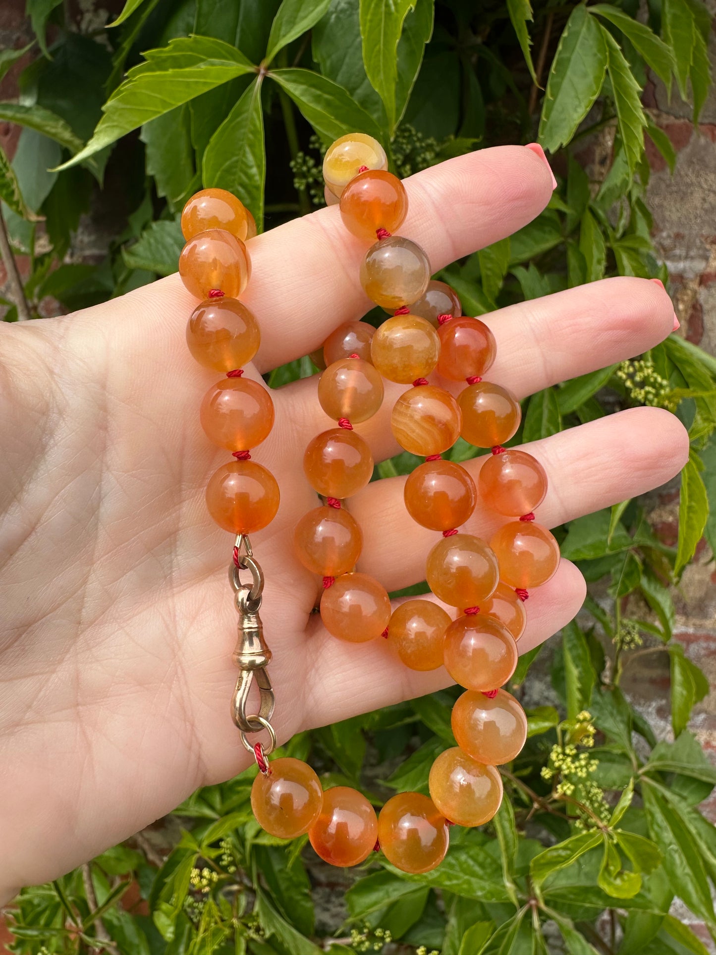 Re-imagined Orange Agate beads with Antique Dog clip