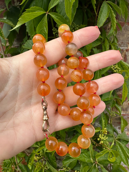 Re-imagined Orange Agate beads with Antique Dog clip