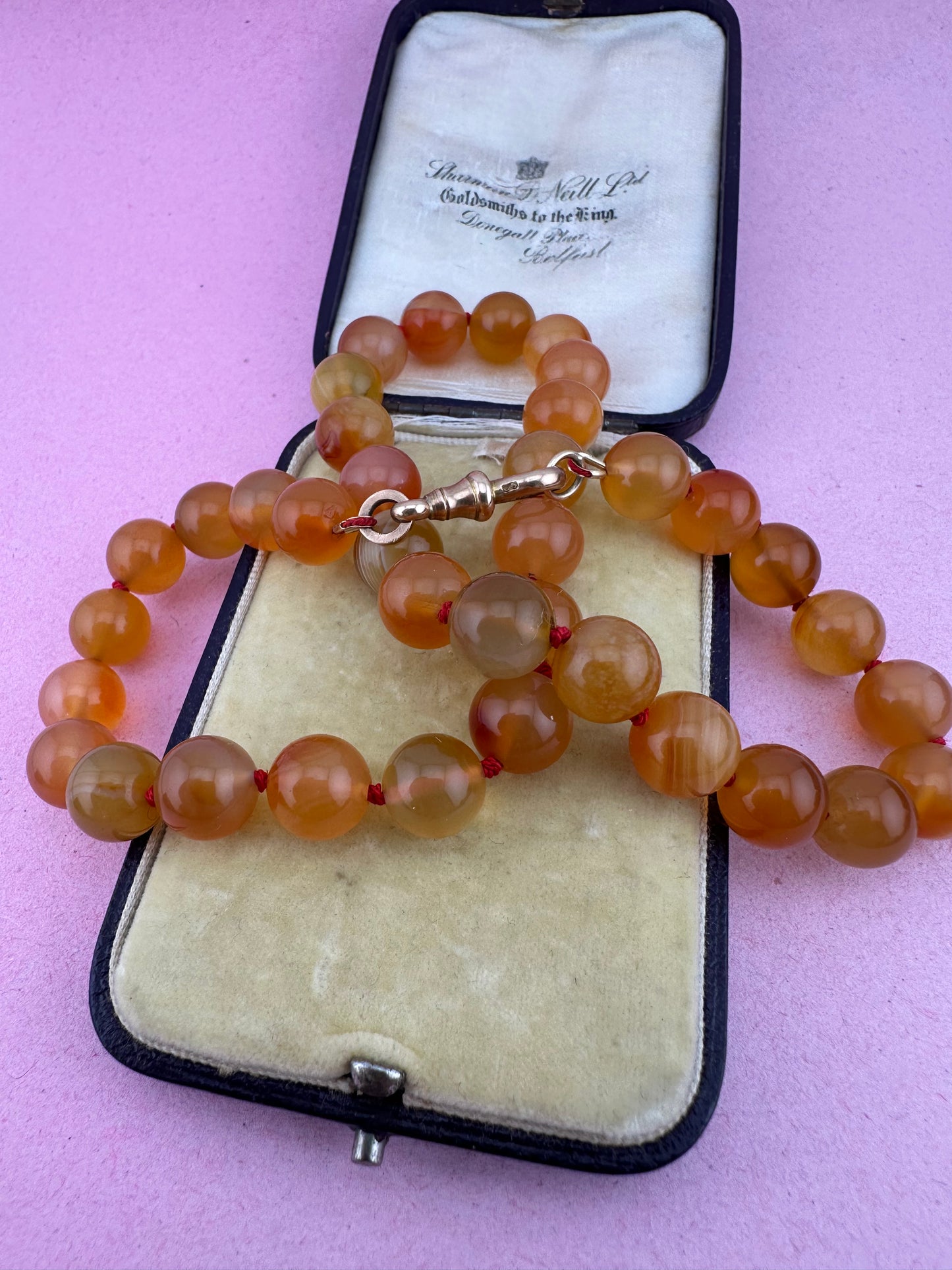 Re-imagined Orange Agate beads with Antique Dog clip