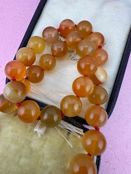 Re-imagined Orange Agate beads with Antique Dog clip