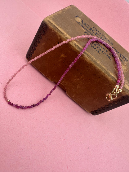Ruby & Pink tourmaline half and half mini beads with antique 9ct gold bolt clasp and central bead.