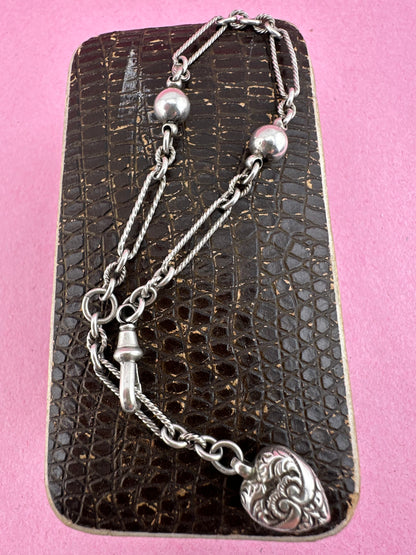 Antique Sterling Silver twist trombone and ball link bracelet with heart charm.