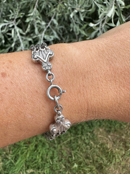 Antique Sterling Silver triple stranded fancy mariner with ornate finials bracelet.