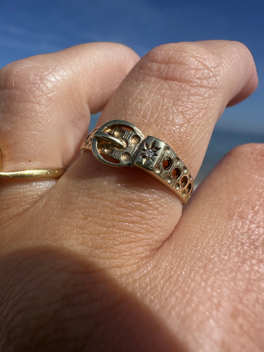 Vintage 9ct Gold Buckle ring with a star set accent diamond.