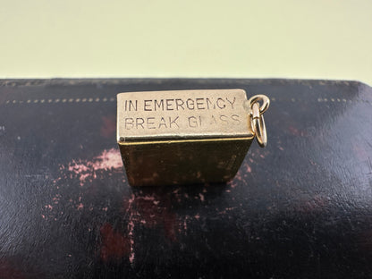 Vintage 9ct gold 10 shilling ‘in emergency break glass’ charm, 1969